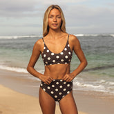 Woman wearing a polka dot bikini on a beach