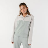 Model wearing two tone half zip sweatshirt and matching sweatpants in neo fabric