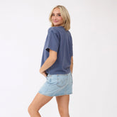 Back three-quarter view of the blue Perfect Oversized Cotton Tee showcasing its oversized fit on a model against a white background