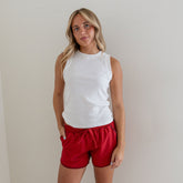 Front view of Varsity Shorts, Red Polka Dot showcasing a relaxed fit on a model against a plain gray background