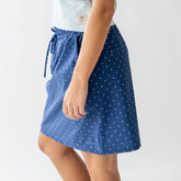 Side view of the City Skirt showcasing its blue polka-dot pattern on a model against a white background