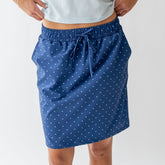 Front view of blue polka dot City Skirt showcasing a drawstring waist with a light background