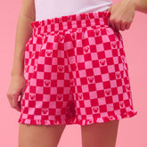 Red and pink checkered shorts with a pattern on a pink background