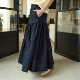 Woman wearing a long maxi skirt in black in an indoor setting