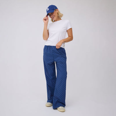 Front view of blue and blue polka dot slip on trouser showcasing the fit on a model against a light background