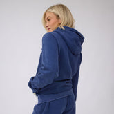 Back view of the navy BYU Campus Hoodie showcasing its hood and ribbed hem on a model against a light gray background