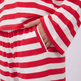 Close-up of red stripe Slip On Jersey Trouser showcasing the side pocket and elastic waistband with a light background