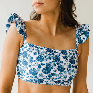 Close up of bandeau swim crop with blue flowers on white