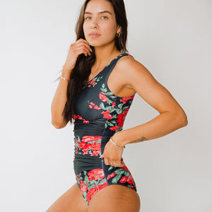 Side view of black and floral one-piece bathing suit