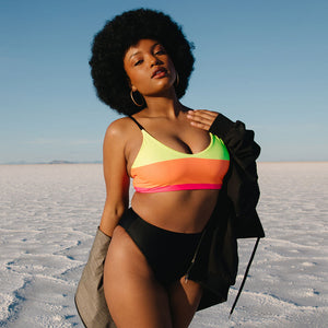 Model wears high cut bikini bottoms from Kelsey Wells Collection by Albion Fit