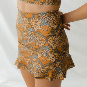 Woman models Golden Hour High-Waisted Swim Skirt by Albion Fit
