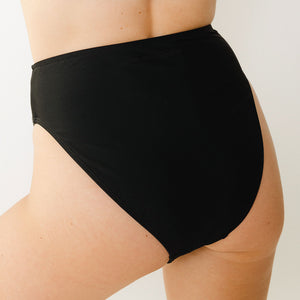 Model wears swim bottoms in black