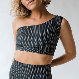 front view of black swim top with white dashes