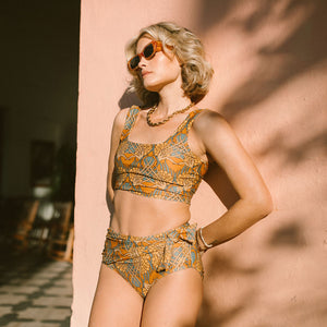 Model in sunglasses wearing midi swim bottoms in Golden Hour
