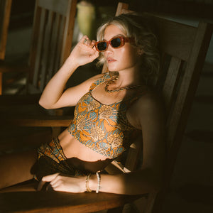 Model wearing sunglasses and golden hour olivia swim crop