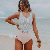 Model posing in striped and floral monokini 