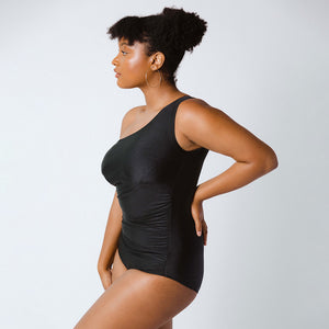 Side view of model in one-piece one-shoulder swimsuit